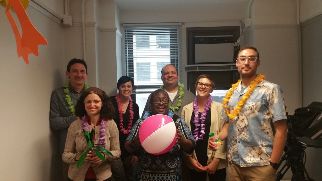 DL staff members with leis and a beach ball.